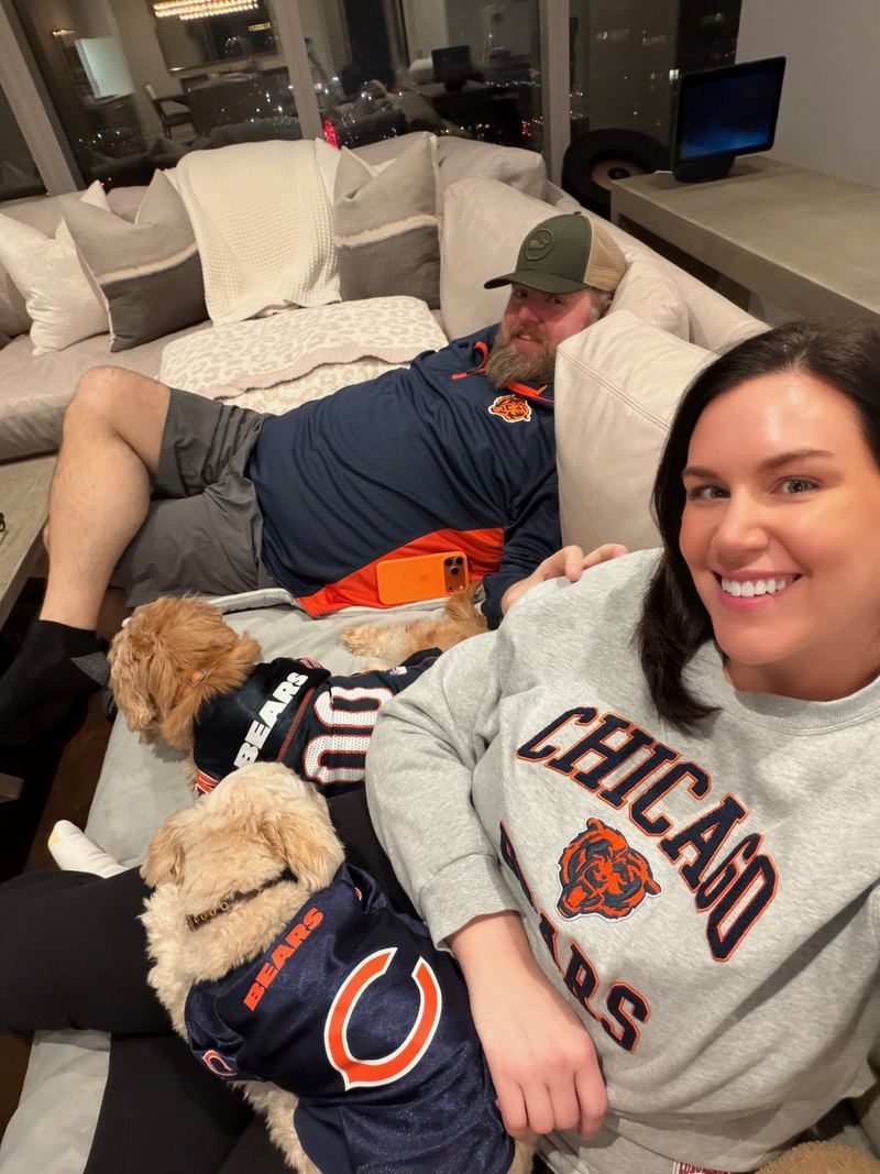 Jen, Curt and the dogs in Bears gear on the couch